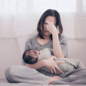 Tired Mother Suffering from experiencing postnatal depression.Health care single mom motherhood stressful.