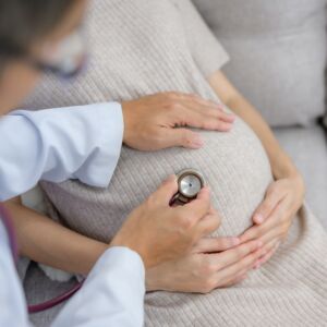 Obstetrician doctor doing health checkup for pregnant woman with large pregnancy and gynecology consultation Examine the stomach Health of pregnant women and prenatal care